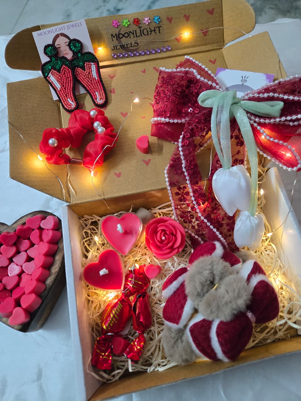 valentine gift box with red hair accessories chocolates and candles
